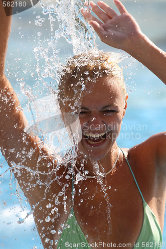 Image of Young beautiful happy smiling tanned blond woman in bikini