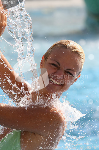 Image of Young beautiful happy smiling tanned blond woman in bikini