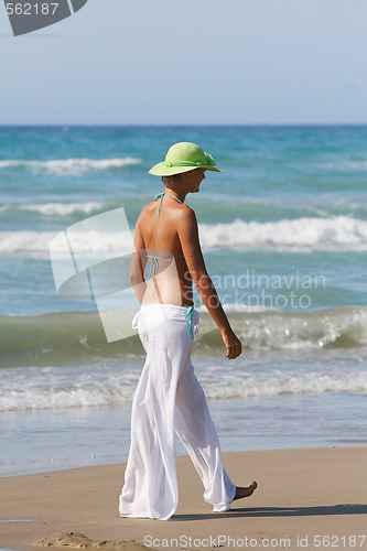 Image of Beautiful young woman relaxing near the sea