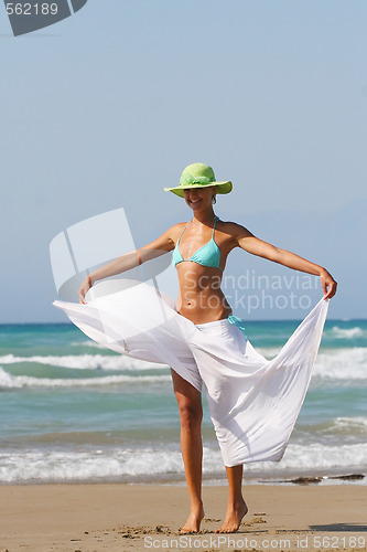 Image of Beautiful young woman relaxing near the sea