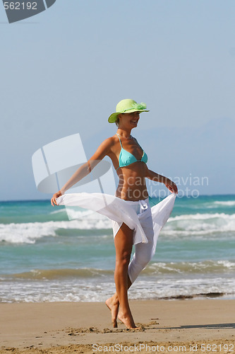 Image of Beautiful young woman relaxing near the sea