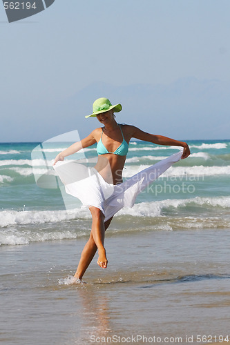 Image of Beautiful young woman relaxing near the sea