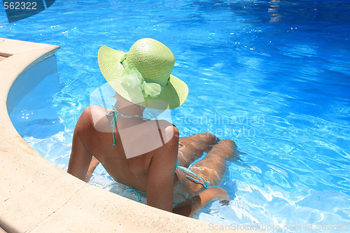 Image of Young woman enjoying a swimming pool