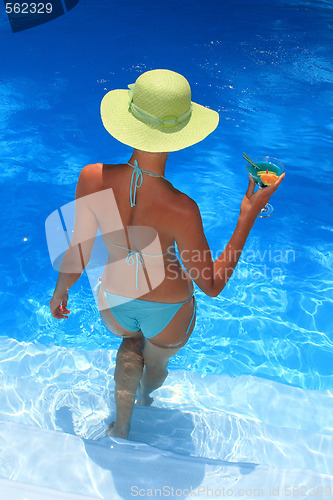 Image of Woman standing  in blue pool