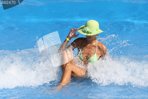 Image of Young woman enjoying a swimming pool