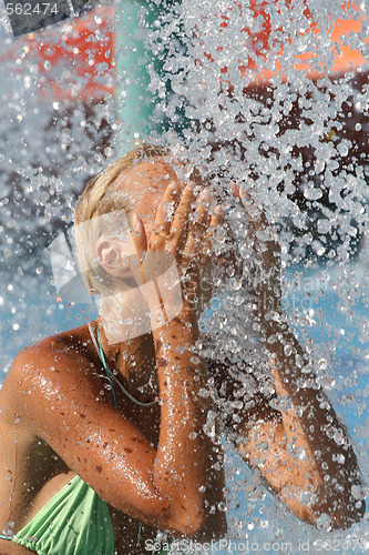 Image of Young beautiful happy smiling tanned blond woman in bikini at rain or summer shower on sea beach