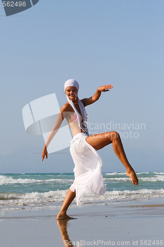 Image of Beautiful girl meditating on the beach