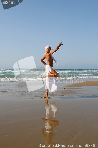 Image of Beautiful girl meditating on the beach