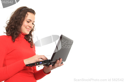 Image of young smiling girl using a laptop