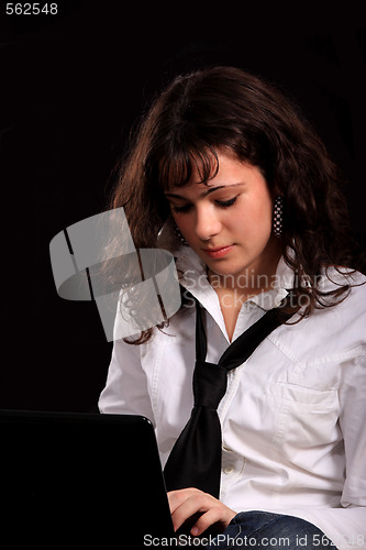 Image of young smiling girl using a laptop