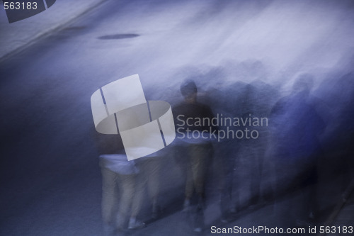 Image of people walking at night