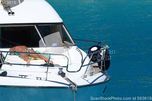 Image of Beautiful woman sun tanning