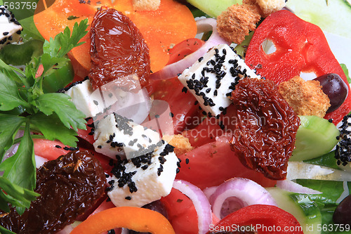 Image of greek salad with tomato, cheese and olives