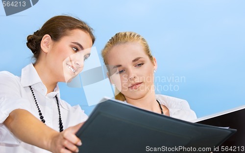 Image of two happy businesswomen with documents