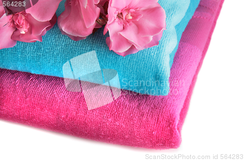 Image of Pink and blue towels with flowers on a table
