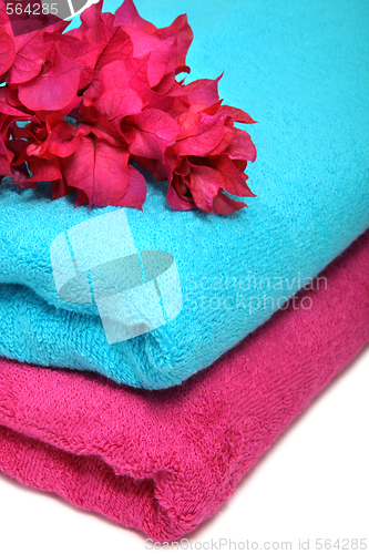 Image of Pink and blue towels with flowers on a table