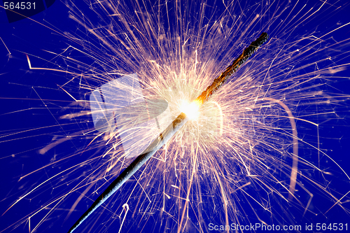 Image of sparkler against blue background.