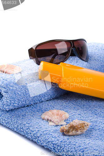 Image of towel, shells, sunglasses and lotion