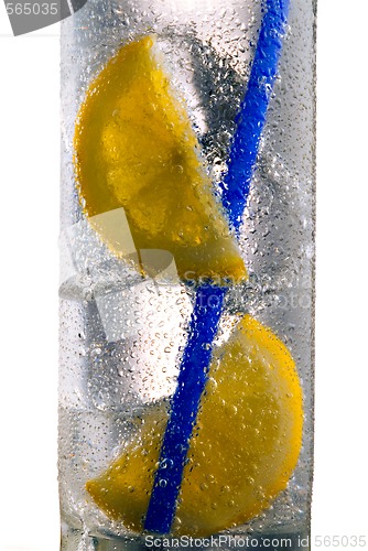 Image of Glass of drink with ice cubes, straw and lemon slice