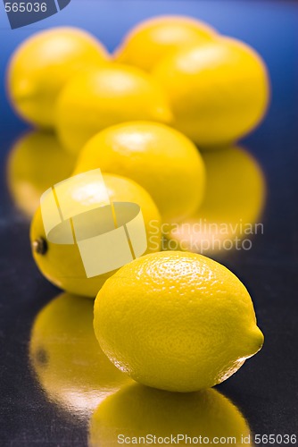 Image of lemons on  blue reflective background