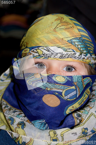 Image of Curious child dressed in the Arabian headscarf