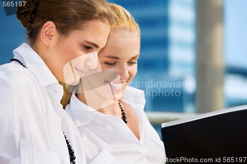 Image of two happy businesswomen with documents