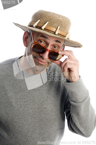 Image of aging artist thinking  suglasses adventure hat