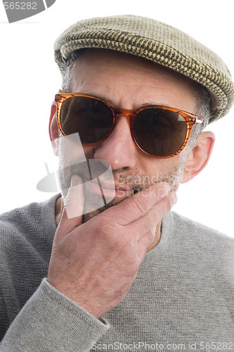 Image of aging artist thinking distorted nose close up scottish tweed hat