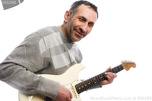 Image of middle age man playing guitar musician