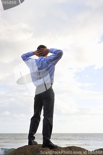 Image of Businessman relaxing at the sea