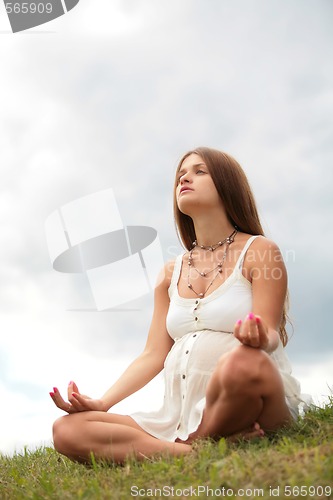 Image of pregnant woman is meditating