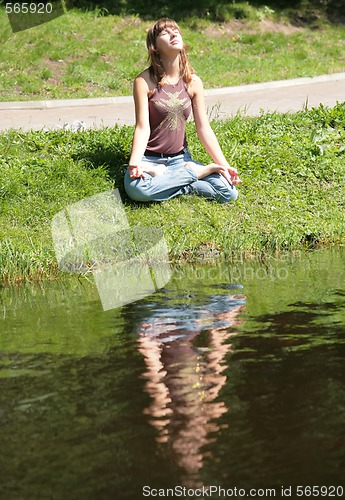 Image of young woman is meditating