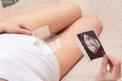 Image of  pregnant woman and ultrasound pictures