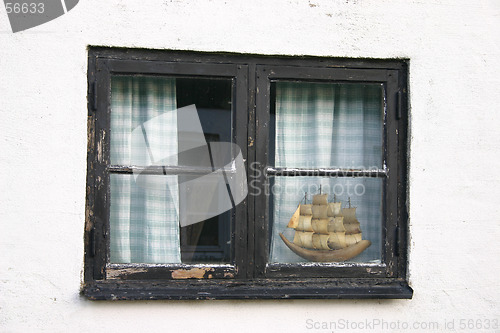 Image of boat awaits in  the window