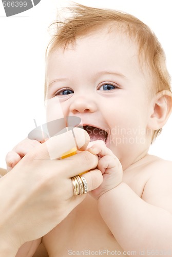 Image of baby boy with yellow plastic toy