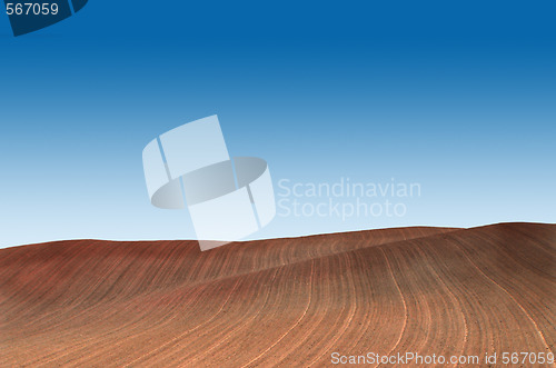 Image of Ploughed field with blue sky