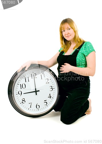 Image of pregnant woman with a clock