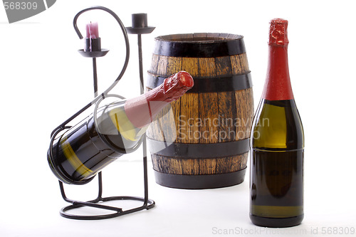Image of Two Bottles,wine barrel, support and candle