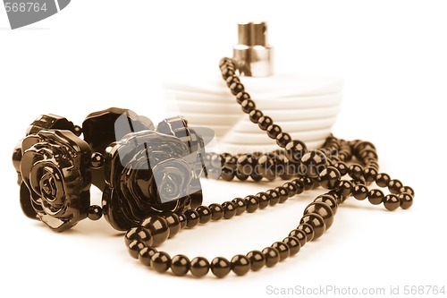 Image of necklace, bracelet and parfume bottle