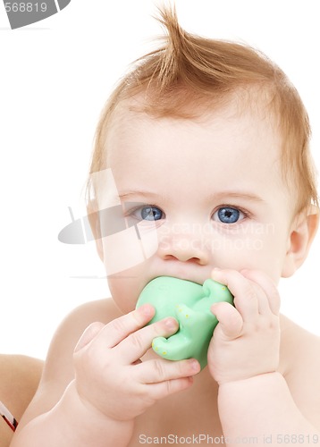 Image of baby boy with green plastic toy