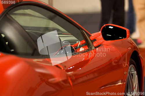 Image of Right side mirror of shiny red car