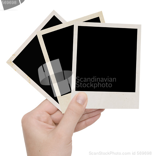 Image of three photo frames in a hand