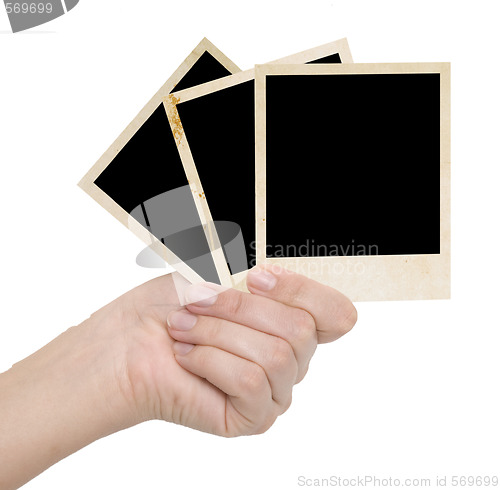 Image of three photo frames in a hand