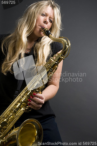 Image of sexy blond female saxophone player musician 