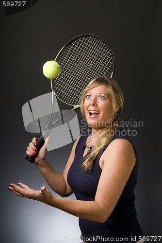 Image of woman tennis player happy serving ball