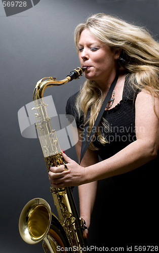 Image of sexy blond female saxophone player musician