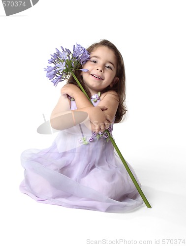 Image of Beautiful smiling girl with pretty flower