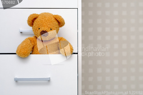 Image of Teddy bear in dresser