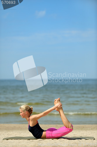 Image of Beautiful female workout on the beach