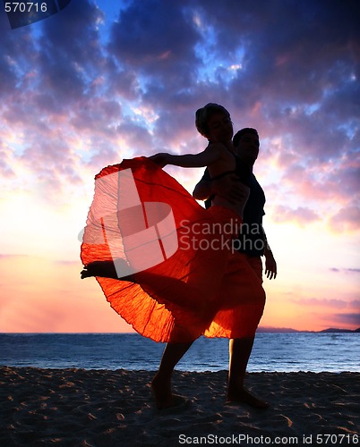 Image of Couple dancing at sunset